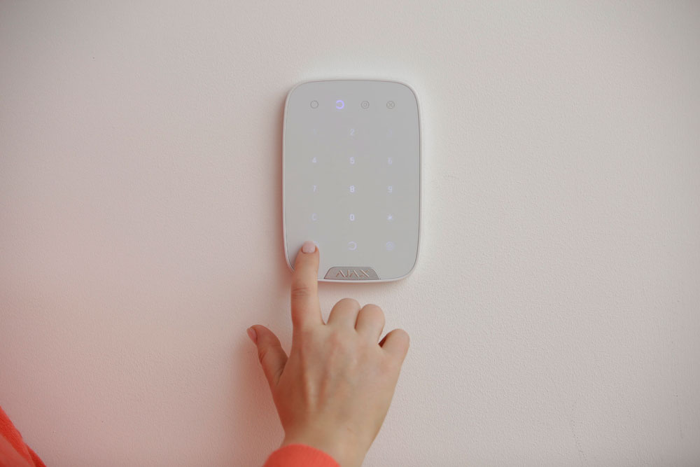 hand-on-alarm-keypad